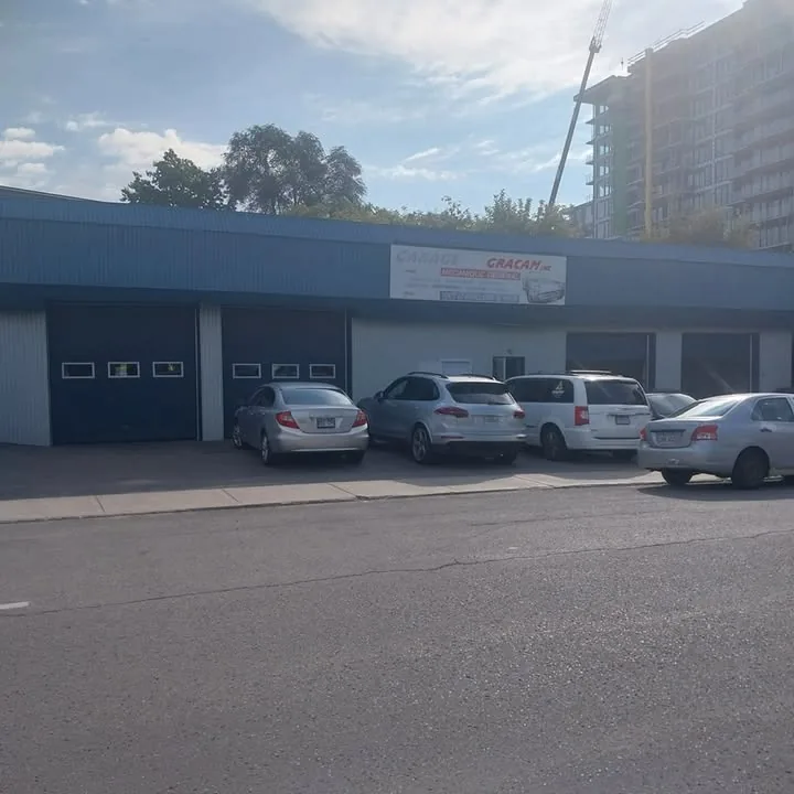 Façade du garage avec enseigne "Garage Gracam" et véhicules stationnés